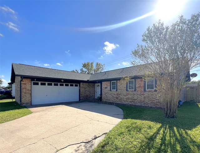 single story home featuring a front lawn and a garage