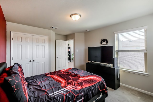 bedroom with light carpet and a closet