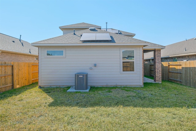 back of property featuring a yard and central AC unit