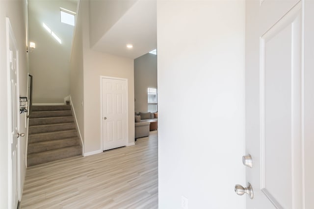 hallway featuring a high ceiling and light wood-type flooring