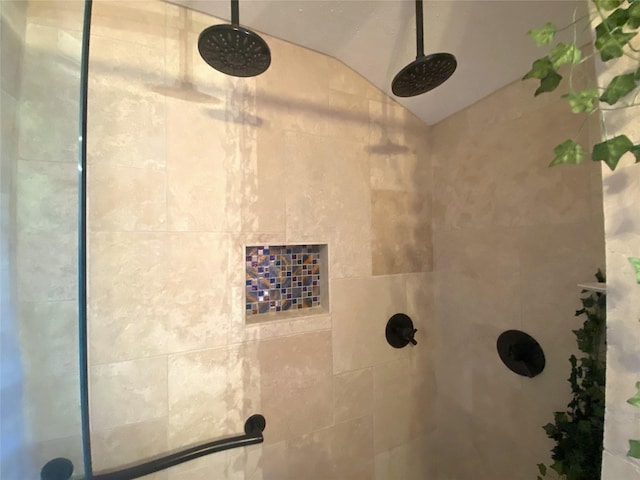 interior details featuring a tile shower