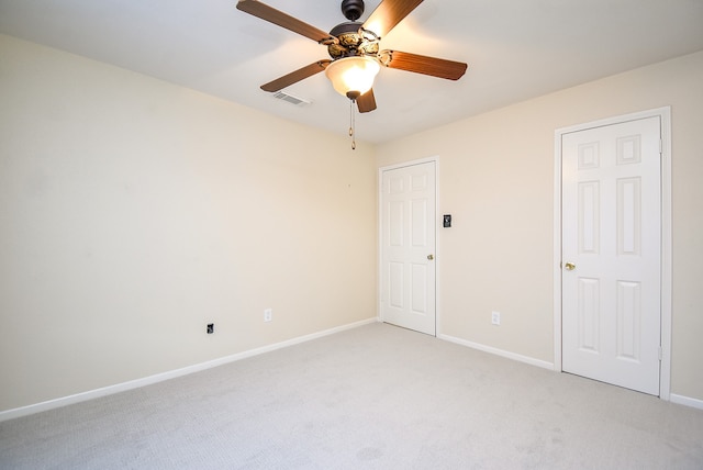 unfurnished room featuring light carpet, baseboards, visible vents, and ceiling fan