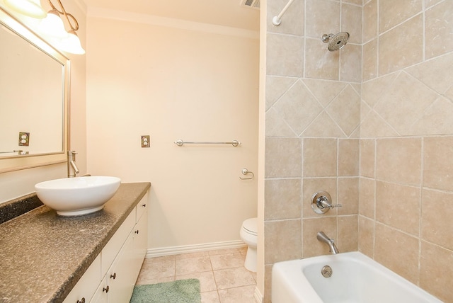 full bathroom featuring vanity, tiled shower / bath, crown molding, tile patterned flooring, and toilet