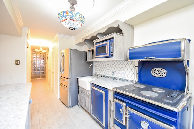 kitchen featuring ornamental molding, blue cabinetry, appliances with stainless steel finishes, and light wood-type flooring