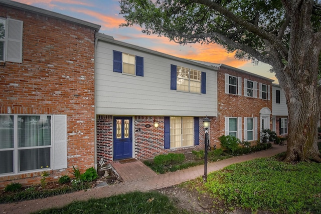 townhome / multi-family property with brick siding