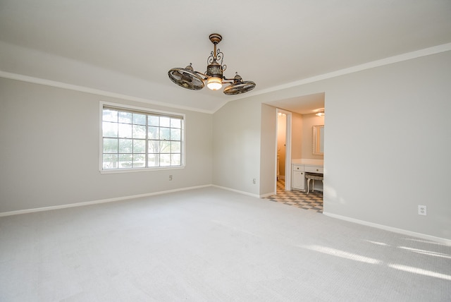 spare room with light carpet, ornamental molding, a chandelier, and baseboards