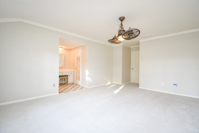 carpeted spare room featuring crown molding