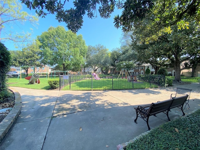 view of home's community with a playground and a lawn