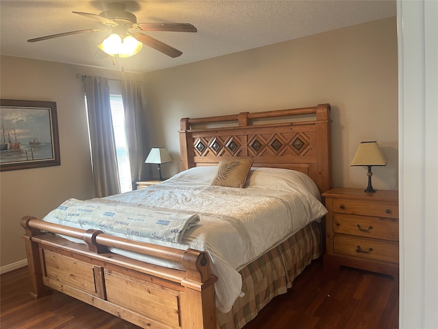 bedroom with dark hardwood / wood-style flooring, a textured ceiling, and ceiling fan