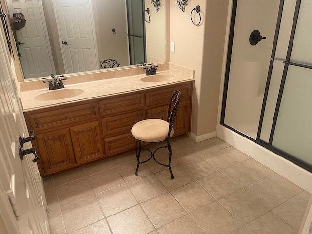 bathroom with vanity, a shower with shower door, and tile patterned floors