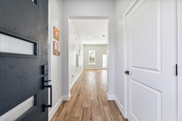 hall with light wood-type flooring