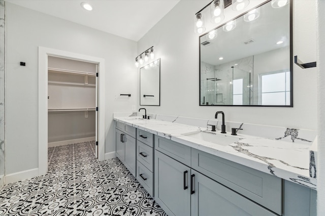 bathroom featuring vanity and a shower with shower door