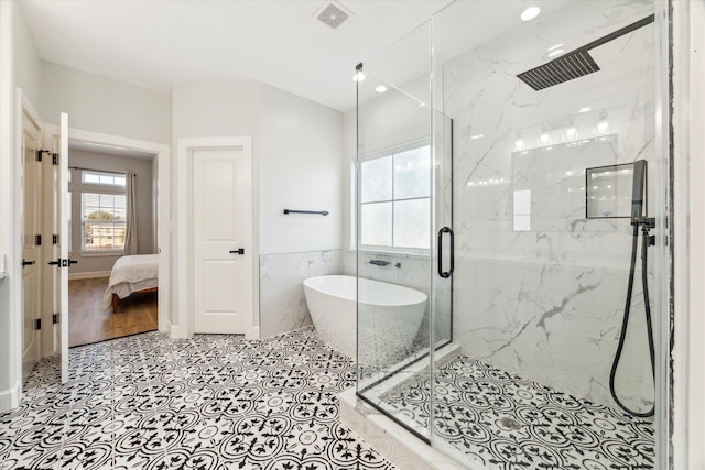 bathroom featuring hardwood / wood-style flooring, tile walls, and independent shower and bath