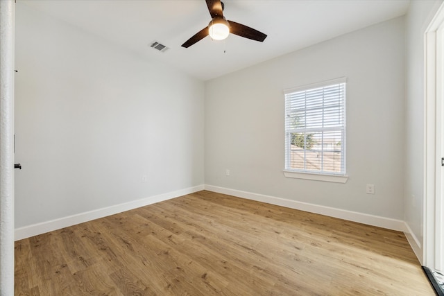 spare room with ceiling fan and light wood-type flooring