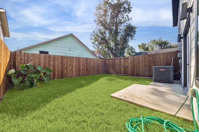 view of yard featuring cooling unit and a patio area