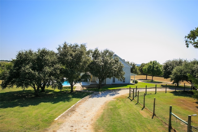 view of home's community featuring a lawn and a rural view