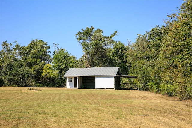 view of outbuilding featuring a lawn