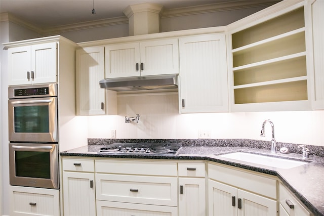 kitchen featuring dark stone countertops, crown molding, sink, and appliances with stainless steel finishes