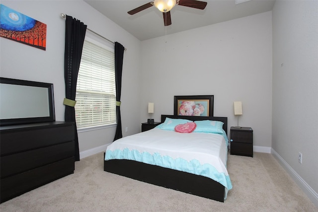 bedroom featuring light carpet and ceiling fan