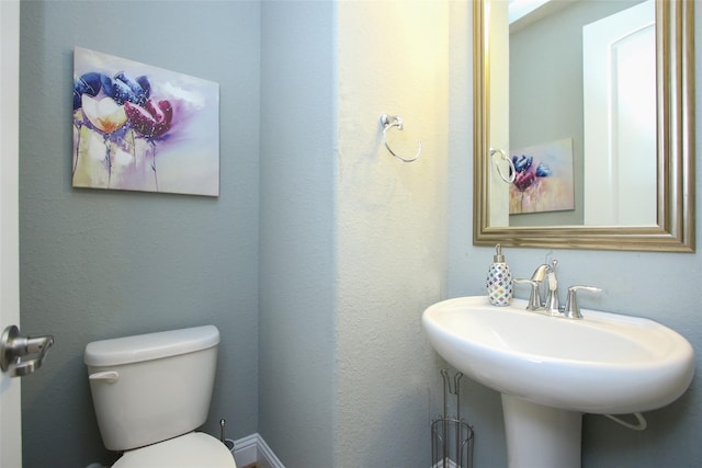 bathroom featuring toilet and sink