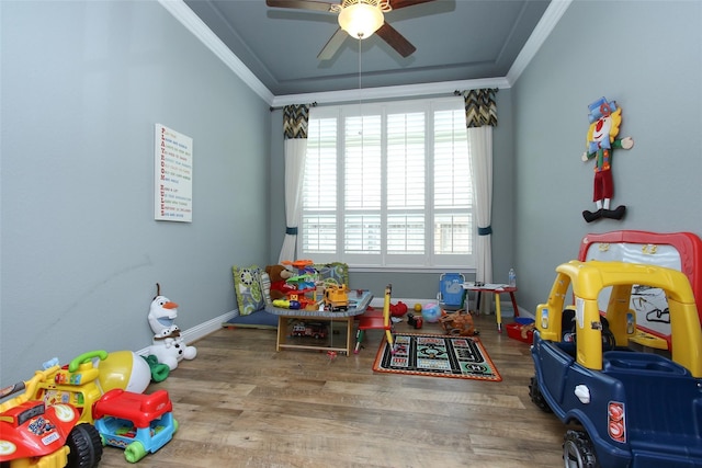 recreation room featuring crown molding, hardwood / wood-style flooring, and ceiling fan