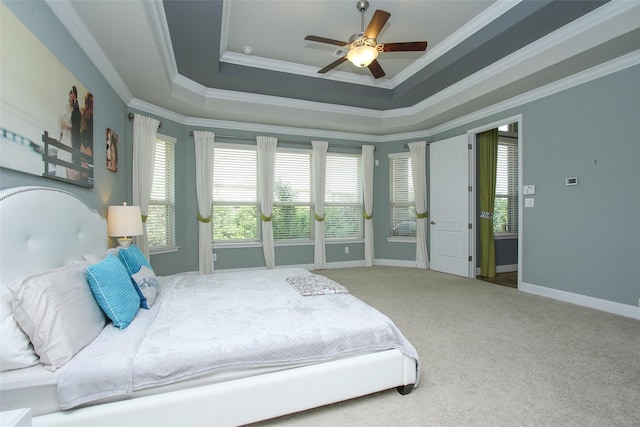 carpeted bedroom with crown molding, a raised ceiling, and ceiling fan