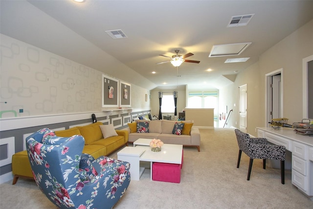 living room featuring vaulted ceiling, light carpet, and ceiling fan