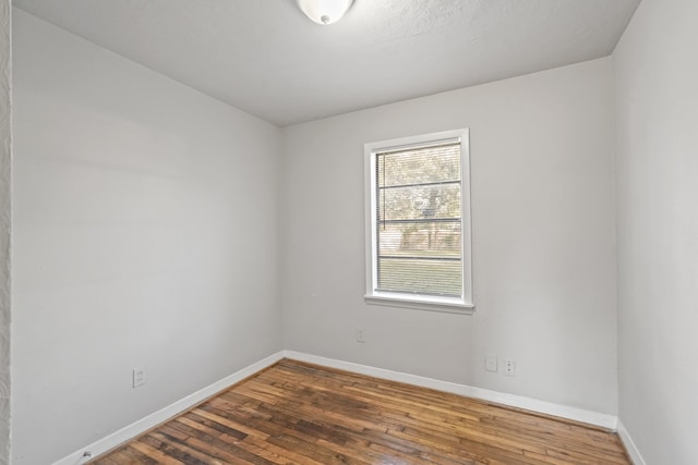 empty room featuring dark wood-type flooring