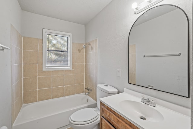 full bathroom with a textured ceiling, vanity, toilet, and tiled shower / bath