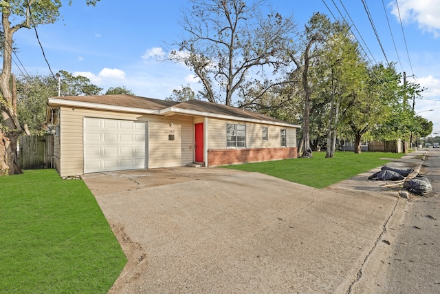 ranch-style house featuring a garage and a front lawn