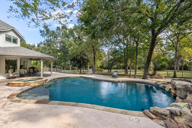 view of pool featuring a patio area and an in ground hot tub