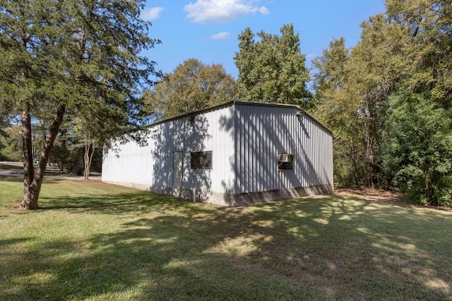 view of outdoor structure featuring a lawn