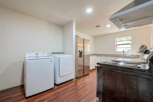 kitchen with washer and dryer, black / electric stove, white cabinets, dark wood-type flooring, and stainless steel refrigerator with ice dispenser