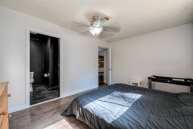 bedroom featuring ceiling fan, ensuite bath, a textured ceiling, and dark hardwood / wood-style floors