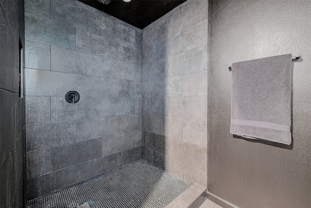 bathroom with tiled shower