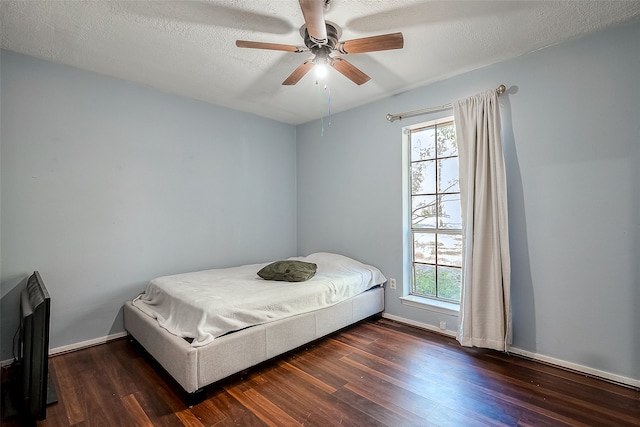 bedroom with dark wood-type flooring, ceiling fan, and multiple windows