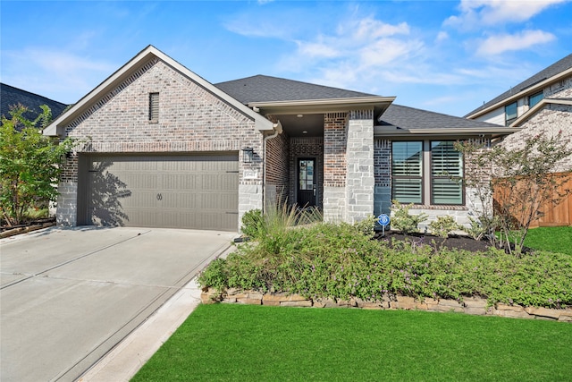 view of front of home with a front lawn and a garage