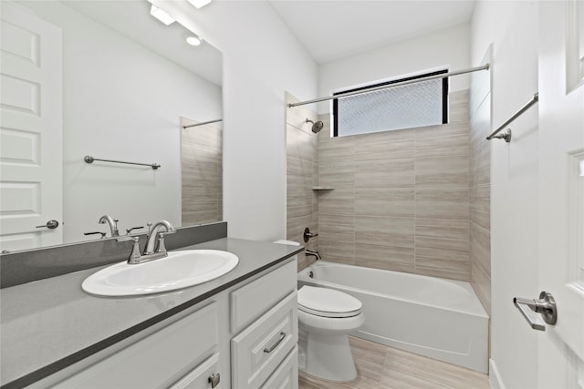 full bathroom with vanity, toilet, tiled shower / bath combo, and hardwood / wood-style floors