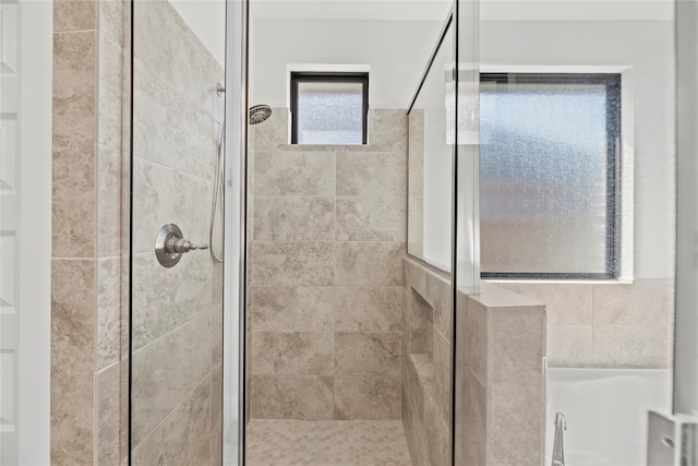 bathroom featuring a shower with door