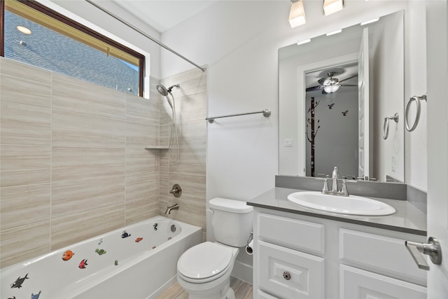 full bathroom with toilet, wood-type flooring, tiled shower / bath, vanity, and ceiling fan