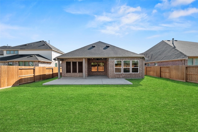 rear view of house featuring a patio area and a lawn