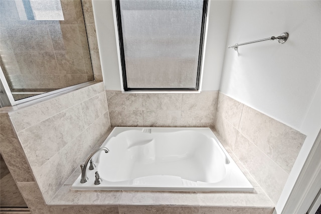 bathroom featuring tiled bath