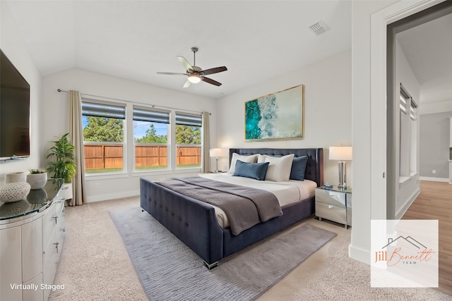 carpeted bedroom featuring ceiling fan and vaulted ceiling