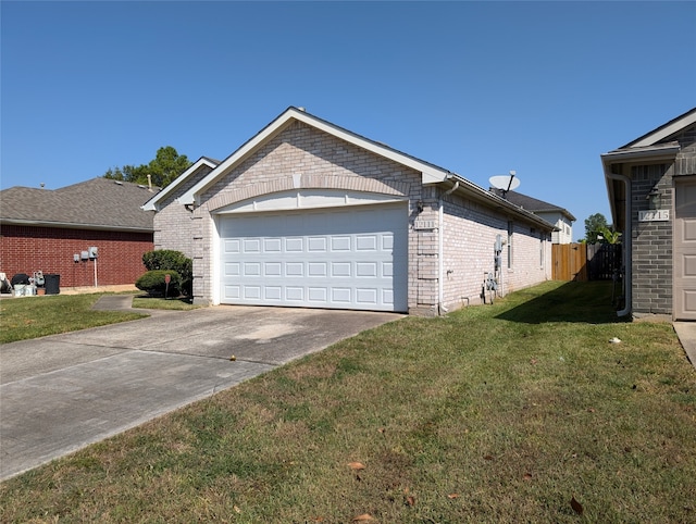 view of side of home featuring a garage and a lawn