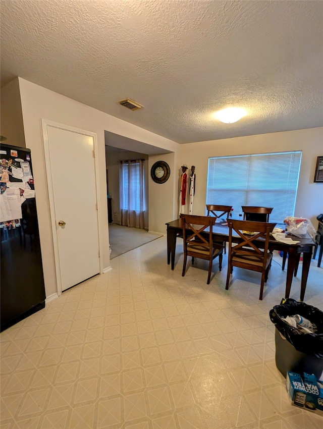 dining area with a textured ceiling