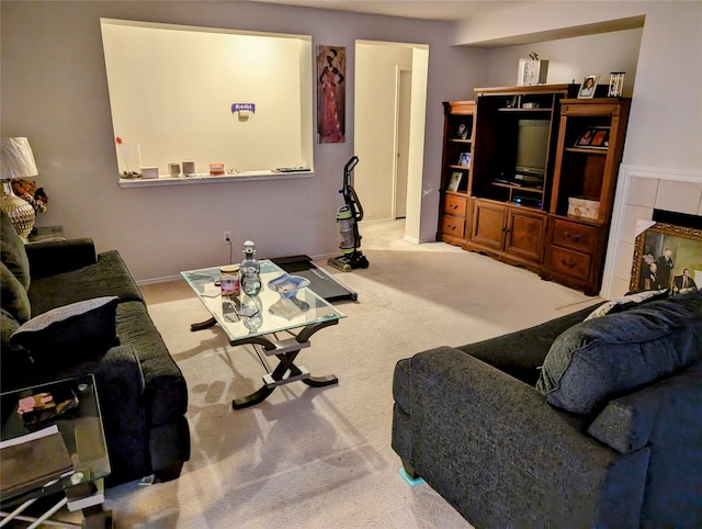 living room featuring light colored carpet and a tile fireplace