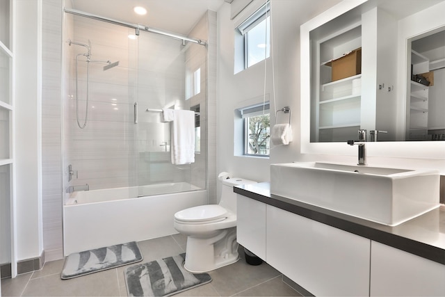 full bathroom with vanity, a wealth of natural light, tile patterned floors, and shower / bath combination with glass door