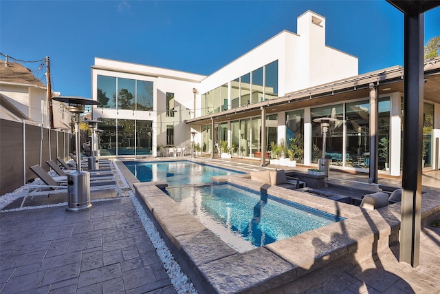 view of pool featuring an in ground hot tub and a patio