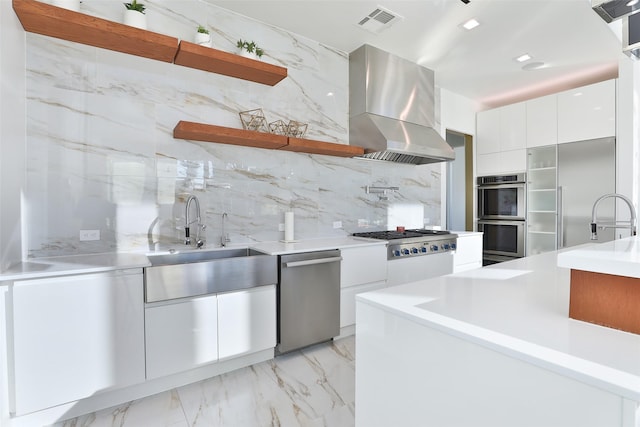 kitchen with backsplash, stainless steel appliances, exhaust hood, and white cabinets