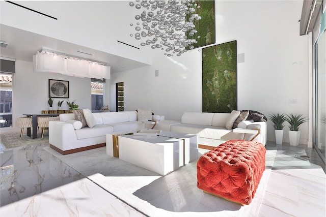 living room featuring a towering ceiling and a wealth of natural light